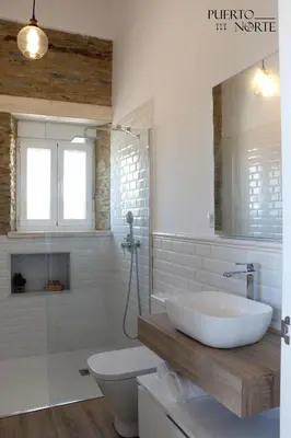 a white bathroom with a sink and a toilet at Apartamentos Puerto Norte - Apto 1 in Puerto de Vega
