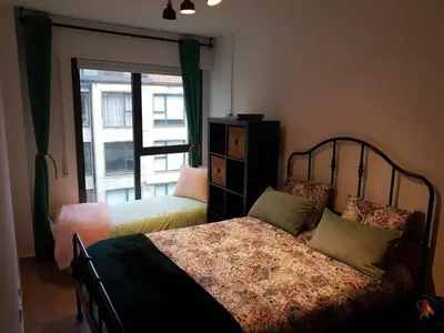 a bedroom with a bed and a window with at Pintoresco piso a 5 min de la playa wifi/Netflix in Ares