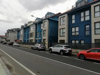 a group of cars parked on the side of a street at Pintoresco piso a 5 min de la playa wifi/Netflix in Ares
