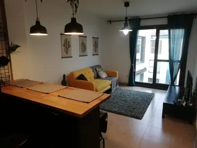 a living room with a couch and a table at Pintoresco piso a 5 min de la playa wifi/Netflix in Ares