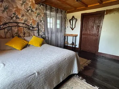 a bedroom with a bed with yellow pillows on it at Albergue Rectoral de Romean in Lugo