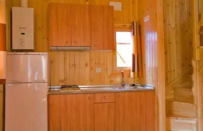 a kitchen with a refrigerator and a sink at La Rectoral de San Juan in El Franco