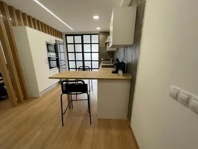 a kitchen with a table and chairs in a room at Oktheway Pedro Saco Street in Sarria