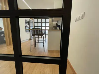 a view of a kitchen through a glass window at Oktheway Pedro Saco Street in Sarria