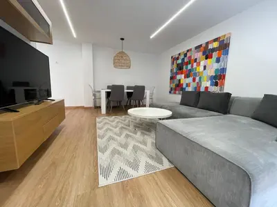 a living room with a couch and a flat screen tv at Oktheway Pedro Saco Street in Sarria