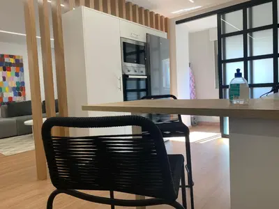 a kitchen with a wooden table and two chairs at Oktheway Pedro Saco Street in Sarria