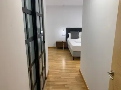 a bedroom with a bed and a bedroom door open at Oktheway Pedro Saco Street in Sarria