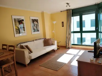 a living room with a couch and a table at Apartamento Playa Catedrales in Barreiros