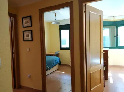a room with a bed and a door to a bedroom at Apartamento Playa Catedrales in Barreiros