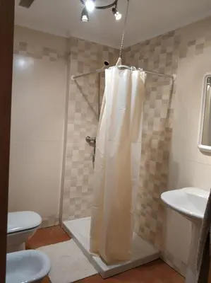 a bathroom with a shower with a shower curtain at Apartamento Playa Catedrales in Barreiros