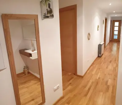 a hallway with a mirror and a sink in a room at Slow House Sarria in Sarria