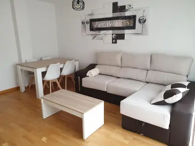 a living room with a couch and a table at Slow House Sarria in Sarria