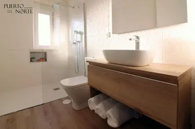 a bathroom with a sink and a toilet and a shower at Apartamentos Puerto Norte - Apto 2 in Puerto de Vega