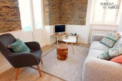 a living room with a couch and chairs and a table at Apartamentos Puerto Norte - Apto 3 in Puerto de Vega