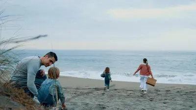 a man and family walking on the beach at Apartamentos Puerto Norte - Apto 3 in Puerto de Vega