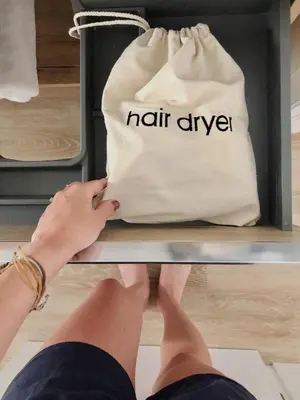 a person with their feet on a shelf with a bag at Apartamentos Puerto Norte - Apto 3 in Puerto de Vega