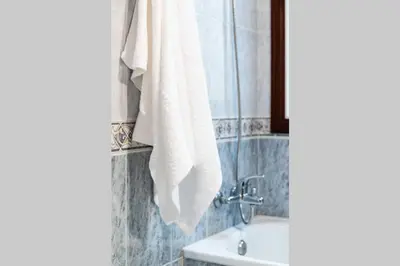 a bathroom with a white towel hanging on a wall at APARTAMENTO EN A ESTRADA/GALICIA in A Estrada