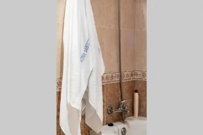 a bathroom with a white towel hanging on a wall at APARTAMENTO EN A ESTRADA/GALICIA in A Estrada
