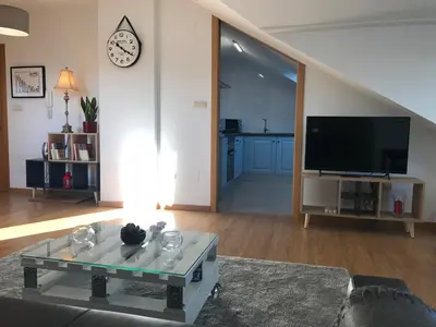 a living room with a tv and a coffee table at APARTAMENTO MANUEL MARIA in Allariz
