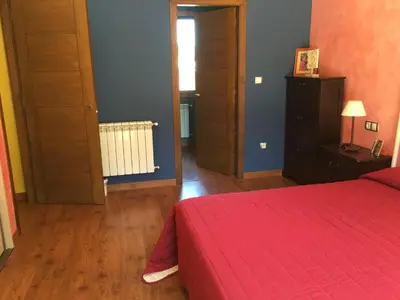 a bedroom with a red bed with a red blanket at A PORTELA - Pereiro de Aguiar in Covas