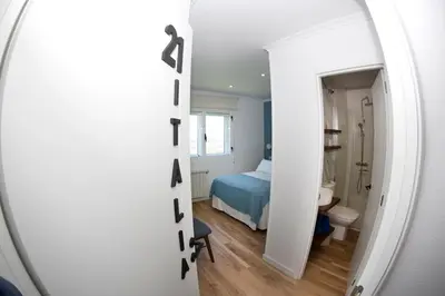 a room with a bed and a room with a mirror at Pension Casa Manolo in Fonsagrada