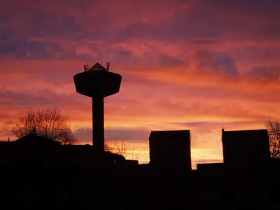 a silhouette of a water tower against a sunset at Pension Casa Manolo in Fonsagrada