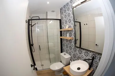 a bathroom with a toilet and a mirror at Pension Casa Manolo in Fonsagrada