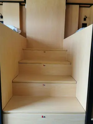 a set of wooden stairs in a room at Los Tres Abetos in Arzúa
