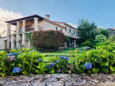 a large house with a garden in front of it at Alojamiento Pazos in Cea