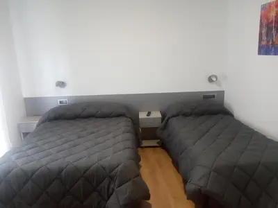 a bedroom with two beds in a room at Hostal Outarelo in Ourense