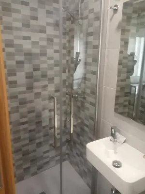 a bathroom with a shower and a sink at Hostal Outarelo in Ourense