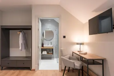 a room with a desk and a sink and a mirror at Hotel Rías Altas in Barreiros
