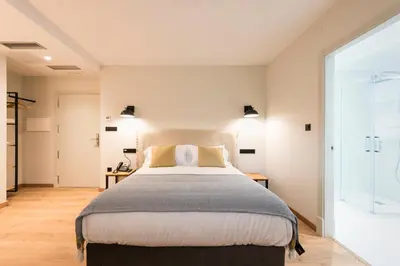 a bedroom with a large bed and a window at Hotel Rías Altas in Barreiros