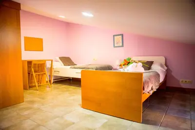 a bedroom with a bed and a table with a doll on it at CASA BELAI in Cuntis