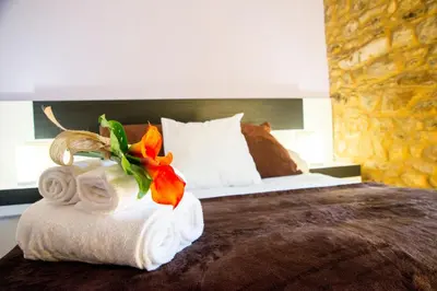 a hotel room with a bed with a pile of towels at CASA BELAI in Cuntis