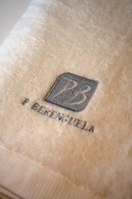a close up of a label on a white shirt at PENSIÓN BERENGUELA in Melide