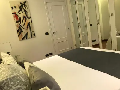 a bedroom with a bed and a painting on the wall at LUXURY DescansoTERMAL in Ourense