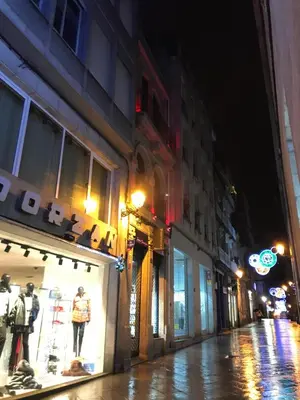 a city street at night with a store front at LUXURY DescansoTERMAL in Ourense