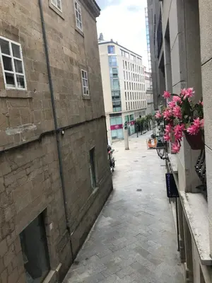 an alley with flowers on the side of a brick building at LUXURY DescansoTERMAL in Ourense