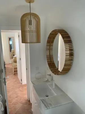a bathroom with a sink and a mirror on the wall at Oktheway Perbes Beach in Boebre