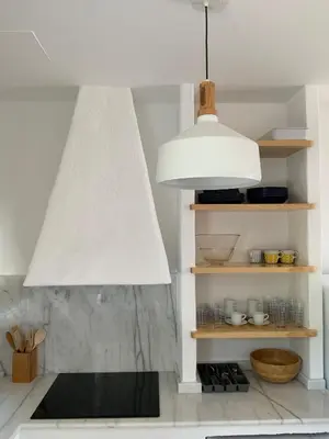 a white kitchen with a large white pendant light at Oktheway Perbes Beach in Boebre