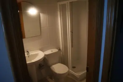 a bathroom with a toilet and a sink and a shower at Gran Vía in Lugo