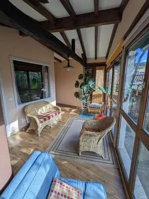 a living room with a blue couch and chairs at Casa do Estevo in Francos