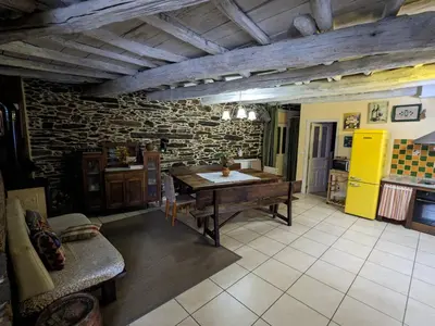 a kitchen with a wooden table in a room at Casa do Estevo in Francos