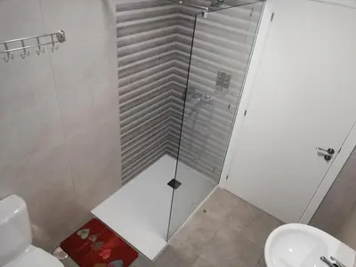 a shower in a bathroom with a toilet and a sink at Pensión La Intermodal in Santiago de Compostela