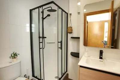 a bathroom with a shower and a sink at VM Apartamentos Turísticos in Santiago de Compostela