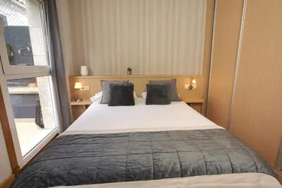 a bedroom with a large bed and a window at VM Apartamentos Turísticos in Santiago de Compostela