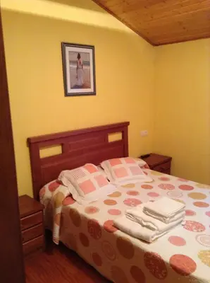 a bedroom with a bed with towels on it at Casa Polín in Las Herrerías