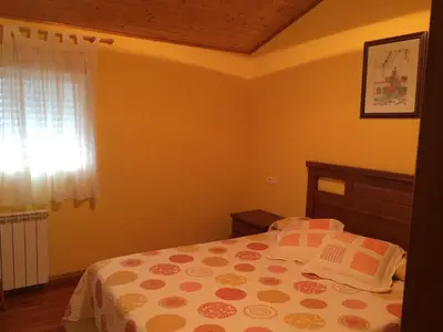 a bedroom with a bed and a window at Casa Polín in Las Herrerías