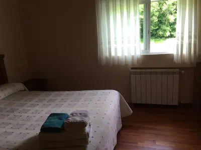 a bedroom with a bed with towels and a window at Casa Polín in Las Herrerías